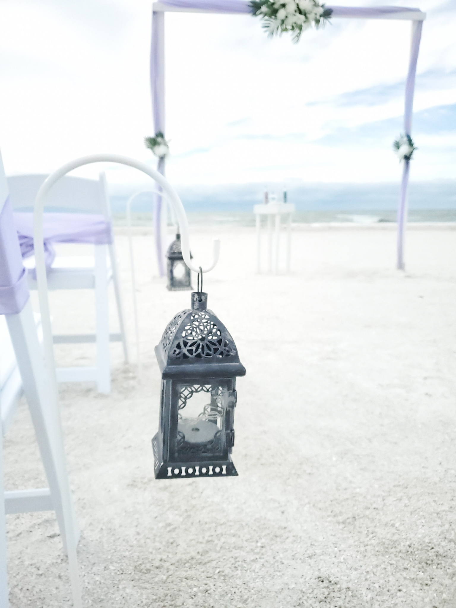 A black and white lantern on the sand